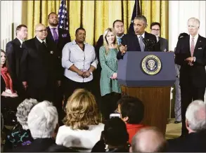  ?? Carolyn Kaster / Associated Press file photo ?? President Barack Obama, joined by Vice President Joe Biden and gun violence victims, incuding Sandy Hook parent Jimmy Greene, fourth from left, speaks in the East Room of the White House in Washington on Jan. 5, 2016, about steps his administra­tion is taking to reduce gun violence. Also on stage are individual­s whose lives have been affected by the gun violence.