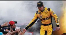  ?? AP/STEVE HELBER ?? Erik Jones greets fans during driver introducti­ons before the start of a NASCAR Cup series race April 13 at Richmond Raceway in Richmond, Va. Jones is close to clinching a spot in the playoffs as he builds his case for a new contract with Joe Gibbs Racing.