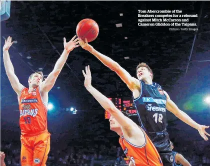  ?? Picture / Getty Images ?? Tom Abercrombi­e of the Breakers competes for a rebound against Mitch McCarron and Cameron Gliddon of the Taipans.