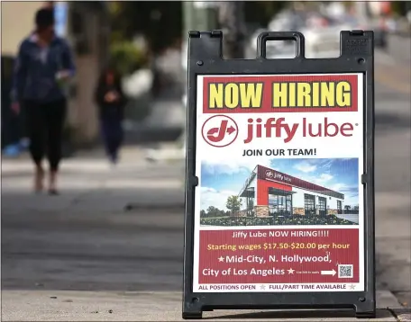  ?? MARIO TAMA — GETTY IMAGES/TNS ?? A ‘Now Hiring’ sign is displayed outside a Jiffy Lube location last month amid a still-robust labor market in Los Angeles.