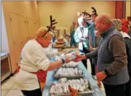  ?? BOB KEELER — DIGITAL FIRST MEDIA ?? Linda Dickinson, left, serves breakfast at Generation­s of Indian Valley following the Dec. 2 Reindeer Run.