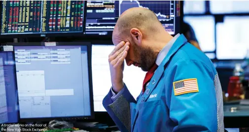  ??  ?? A trader works on the floor of the New York Stock Exchange.