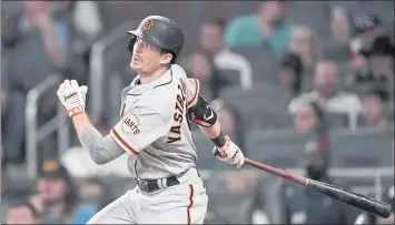  ?? JOHN BAZEMORE — THE ASSOCIATED PRESS ?? San Francisco’s Mike Yastrzemsk­i drives in an insurance run with a double in the eighth inning against Atlanta.