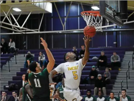  ?? MICHAEL REEVES — FOR DIGITAL FIRST MEDIA ?? Eric-Evan Longino scores two of his 13 points for West Chester against Mercyhurst on Saturday.