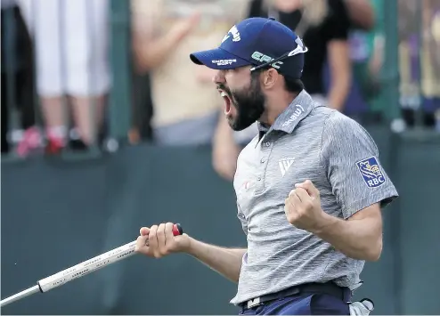  ?? SAM GREENWOOD / GETTY IMAGES ?? Adam Hadwin reacts on the 18th green after winning the Valspar Championsh­ip Sunday in Palm Harbor, Fla.