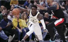  ??  ?? Indiana Pacers guard Darren Collison (2) drives on Portland Trail Blazers guard Damian Lillard (0) during the first half of an NBA basketball game in Indianapol­is, on Monday. AP PHOTO/MICHAEL CONROY