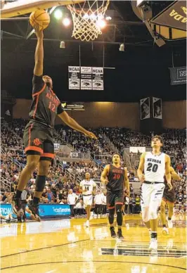  ?? SARA RUMFORD NEVADA ATHLETICS ?? Darrion Trammell goes in for a layup after a first-half steal. He had 10 points. Nevada fans chanted at him before and after the bucket, calling him a midget.