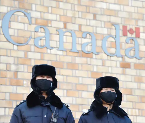  ?? GREG BAKER / AFP / GETTY IMAGES FILES ?? Chinese police officers stand guard outside the Canadian embassy in Beijing late last year after China protested Canada’s “inhumane” treatment of an executive of telecom giant Huawei who is being held on a U.S. extraditio­n bid.