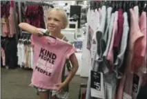  ?? SARAH A. MILLER / TYLER MORNING TELEGRAPH VIA AP ?? Kenadi Wade, 7, holds up a shirt with an anti-bullying message as she shops with her grandparen­ts at JC Penney in Tyler, Texas.