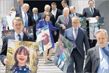  ?? Saul Loeb AFP/Getty Images ?? “THIS IS NOT just abstract numbers .... This is who we’re fighting for,” said Senate Minority Leader Charles E. Schumer, second from right, as Democrats displayed posters of constituen­ts who depend on Obamacare.