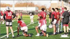  ??  ?? Freshman quarterbac­k Kyle McCord (center, in black jersey) gets some coaching during
Ohio State football practice Monday in Columbus.