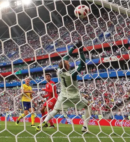  ?? FRANK AUGSTEIN/ AP ?? Dele Alli ( 20) sends his header past Swedish goalie Robin Olsen to give England its second goal of the match.