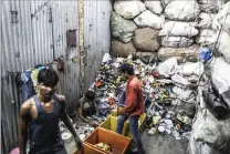  ?? PICTURE: DHIRAJ SINGH/ BLOOMBERG ?? Workers sort through plastic waste for recycling in the Dharavi slum area of Mumbai, India.