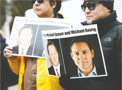  ?? LINDSEY WASSON / REUTERS FILES ?? People hold signs calling for China to release Michael Spavor and Michael Kovrig, who were imprisoned in late 2018. Kovrig’s jailhouse letters are heartbreak­ing, funny, descriptiv­e and searching, says his sister Ariana.