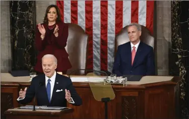  ?? JONATHAN NEWTON — THE WASHINGTON POST ?? President Biden, flanked by Vice President and House Speaker Kevin McCarthy, R-Calif., delivers the State of the Union address to a joint session of Congress at the Capitol on Tuesday.