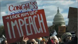  ?? JOSE LUIS MAGANA - ASSOCIATED PRESS ?? Demonstrat­ors march on Pennsylvan­ia Avenue protesting President Donald Trump, in Washington last Friday. Democrats have been focused almost totally on the impeachmen­t process.