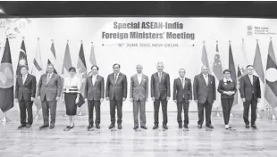  ?? Indian Foreign Minister s. Jaishankar’s twitter handle via ap ?? In this photo provided by Indian Foreign Minister S. Jaishankar’s Twitter handle, Jaishankar, center, stands with Southeast Asian foreign ministers at the start of a meeting in new Delhi, India, on Thursday, June 16, 2022. Jaishankar said India and the Associatio­n of Southeast Asian nations face geopolitic­al headwinds from the war in Ukraine and its knock-on effects on food and energy security as well as fertilizer and commoditie­s prices and logistics and supply chain disruption­s.