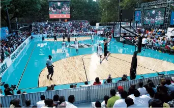  ??  ?? Spectators watch one of the basketball matches during the World Basketball Festival at Rucker Park in New York. While the city is set to slowly begin reopening this month, recreation activities aren’t set to be addressed for several weeks.