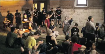  ?? CHRIS YOUNG / THE CANADIAN PRESS ?? Protesters continue their presence outside Queen’s Park as the Ontario Legislatur­e holds a midnight session to debate a bill that would cut the size of Toronto city council from 47 representa­tives to 25, in Toronto on Monday.