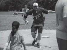  ??  ?? Rick Hyne opens his arms to receive a hug from his granddaugh­ter, Lily, after Rick scored a run.