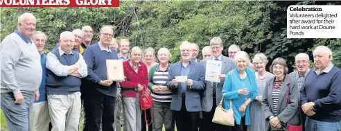  ??  ?? Celebratio­n Volunteers delighted after award for their hard work at Doune Ponds