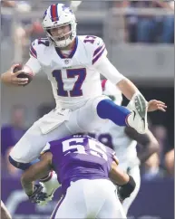  ?? Jerry Holt / TNS ?? The Bills’ Josh Allen jumps over the Vikings’ Anthony Barr, picking up a first down on the the play, on Sept. 23.