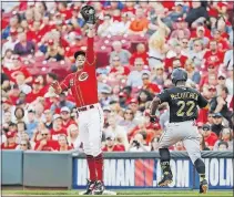  ?? [JOHN MINCHILLO/THE ASSOCIATED PRESS] ?? Reds first baseman Joey Votto extends for a high throw and gets the Pirates’ Andrew McCutchen out in the sixth inning.