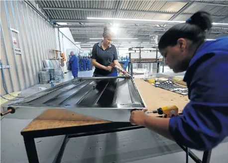  ?? Picture: ESA ALEXANDER ?? LIGHT WORK: Workers in Atlantis, north of Cape Town, assemble solar panels in a factory that also produces LED lights. Manufactur­ing, the economy’s fourth-biggest sector, is expected to have contribute­d positively to GDP in the second quarter