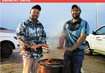  ?? Picture: SUE MACLENNAN ?? FROM THE HEART: Port Alfred Round Table members Nico von Wielligh and Brendan Marais warm their hands over a brazier in the West Beach parking lot last Friday evening to raise awareness for their Winter Knights charity collection campaign