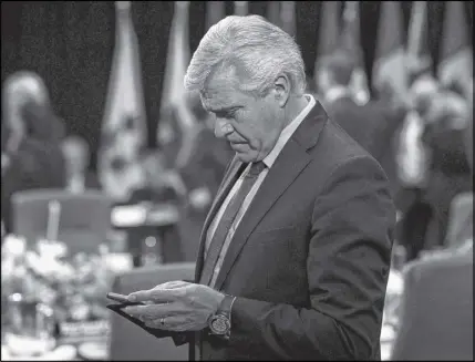  ?? CP PHOTO ?? Newfoundla­nd and Labrador Premier Dwight Ball to begin in Ottawa. checks his mobile device as he waits for the First Ministers Meeting