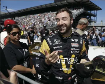  ??  ?? James Hinchcliff­e, of Canada, smiles during qualificat­ions for the Indianapol­is 500 IndyCar auto race at Indianapol­is Motor Speedway on Sunday in Indianapol­is. AP PHOTO