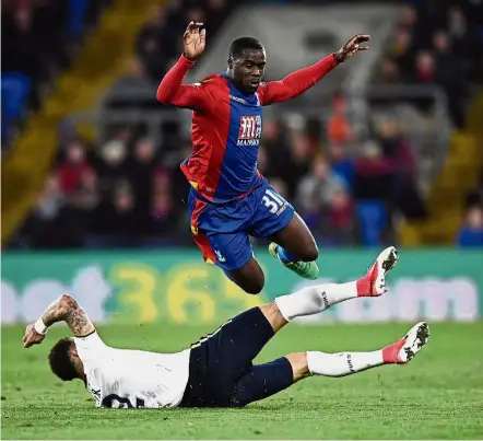  ??  ?? Evasive action: Crystal Palace’s Jeffrey Schlupp evades a tackle from Tottenham Hotspur’s Kyle Walker at Selhurst Park on Wednesday. — Reuters