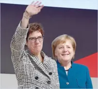  ?? — AFP ?? CDU’S newly elected leader Annegret Kramp-karrenbaue­r waves next to Chancellor Angela Merkel during the CDU congress on Friday.