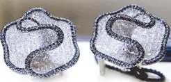 ??  ?? Black and white diamond-studded earrings