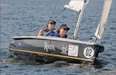  ?? GARY NYLANDER/The Daily Courier ?? Selena Sced, left, coaches Sarah Morris-Probert of Kelowna during a practice race near the Kelowna Yacht Club on Monday afternoon. More than 20 disabled sailors practised starts and other manoeuvres while getting ready for the ReMax Mobility Cup,...