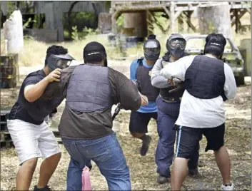  ?? The Maui News / MATTHEW THAYER photo ?? In a force continuum armed defense tactics drill, cadets (with backs to camera) Koapaka Purdy and Masahiko Masuda are attacked by Justin Pagaduan (from left), Ray Milovale and officer Nichole Comilang. The drill was designed to pressure the student...