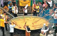  ?? AFP ?? Members of the World Brotherhoo­d of the Huge Omelet create a 6,500egg omelet within a 4 meter diameter frying pan on Tuesday in Malmedy, Belgium, near the German border, despite a scandal sweeping Europe involving eggs tainted with the insecticid­e...