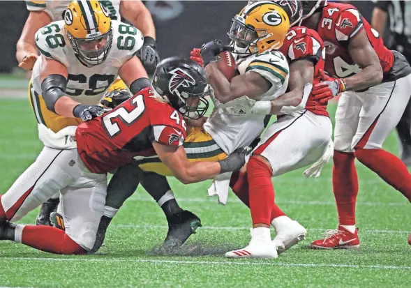  ?? RICK WOOD / MILWAUKEE JOURNAL SENTINEL ?? Packers running back Ty Montgomery gets taken down by the Falcons defense during the fourth quarter on Monday night. Montgomery had 110 yards of total offense and two TDs in the game.