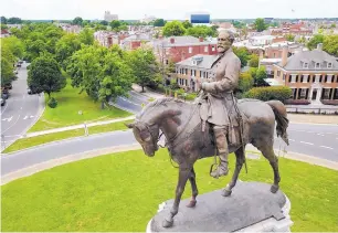  ?? STEVE HELBER/ASSOCIATED PRESS ?? A statue of Confederat­e General Robert E. Lee stands in Richmond, Va. Vestiges of the Civil War and segregatio­n are coming down as part of a national reckoning on white supremacy.