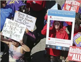  ?? REED SAXON — THE ASSOCIATED PRESS ?? People march in 2017, protesting President Donald Trump’s plan to dismantle the Affordable Care Act. Democratic governors are fighting to restore parts of the act.