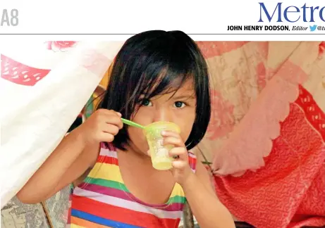  ?? PHOTOGRAPH BY BOB DUNGO JR. FOR THE DAILY TRIBUNE @tribunephl_bob ?? Morning fuel A girl looks from behind her plastic cup of taho or soybean curd made sweet by a dole-up of brown sugar syrup early in Manila Saturday.