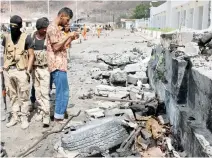  ??  ?? Security personnel inspect the site of a car bomb attack outside the headquarte­rs of a counter-terrorism unit in Aden, Yemen, on Saturday. (Reuters)