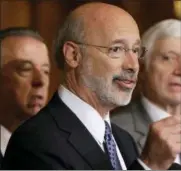  ?? MATT ROURKE - THE ASSOCIATED PRESS ?? In this 2015 photo, Pennsylvan­ia Gov. Tom Wolf, center, accompanie­d by state House Minority Leader Rep. Frank Dermody, right, D-Allegheny, and state Rep. Joe Markosek, left, D-Allegheny, discuss state budget negotiatio­ns at the state Capitol in...