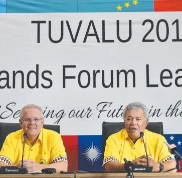  ?? Picture: AAP IMAGE/MICK TSIKAS ?? GRANDSTAND­ING: Australia's Prime Minister Scott Morrison and Tuvalu's Prime Minister Enele Sopoaga at a press conference during the Pacific Islands Forum.