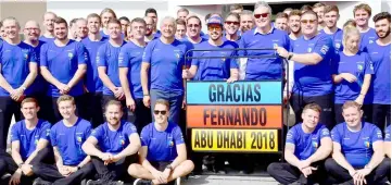  ??  ?? McLaren’s Spanish driver Fernando Alonso (fifth right) poses for a photograph with his team ahead of the Abu Dhabi Formula One Grand Prix, his last race for McLaren, at the Yas Marina circuit. — AFP photo