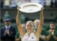  ?? TIM IRELAND — THE ASSOCIATED PRESS ?? Germany’s Angelique Kerber lifts the trophy after winning the women’s singles final match against Serena Williams of the United States, at the Wimbledon Tennis Championsh­ips, in London, Saturday.