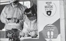  ?? WALDO SWIEGERS / BLOOMBERG VIA GETTY IMAGES ?? A health worker administer­s a nasal swab at a COVID-19 mobile testing site in Johannesbu­rg, South Africa, on Thursday.