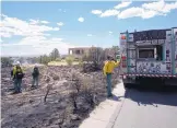  ?? ADOLPHE PIERRE-LOUIS/JOURNAL ?? Albuquerqu­e and Bernalillo County firefighte­rs snuff a brush fire that burned near some homes in the Sandia foothills Tuesday afternoon.