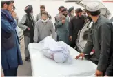  ?? AP ?? Afghans carry the body of a man who was killed during a deadly attack, in the southern Helmand province, Monday.