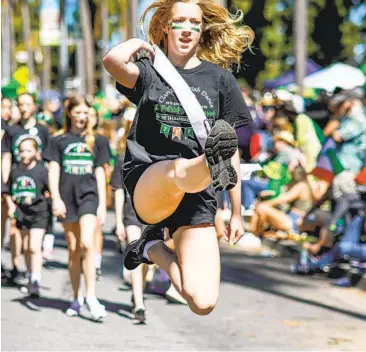  ?? SANDY HUFFAKER FILE PHOTO FOR THE U-T ?? Dancers from the local Clan Rince School of Irish Dance perform in the 2022 St Patrick’s Day Parade on Sixth Avenue in San Diego. Some students travel around the region and world, and March is an especially active time.